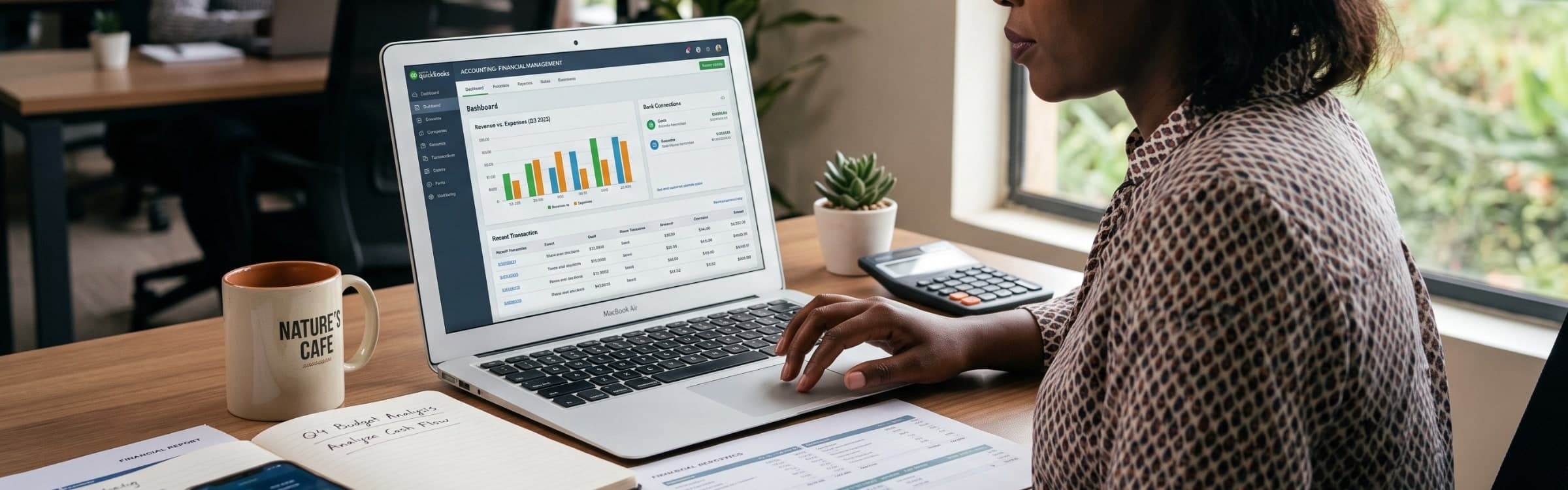 Someone reviewing a bookkeeping dashboard on a laptop at a sunlit desk.